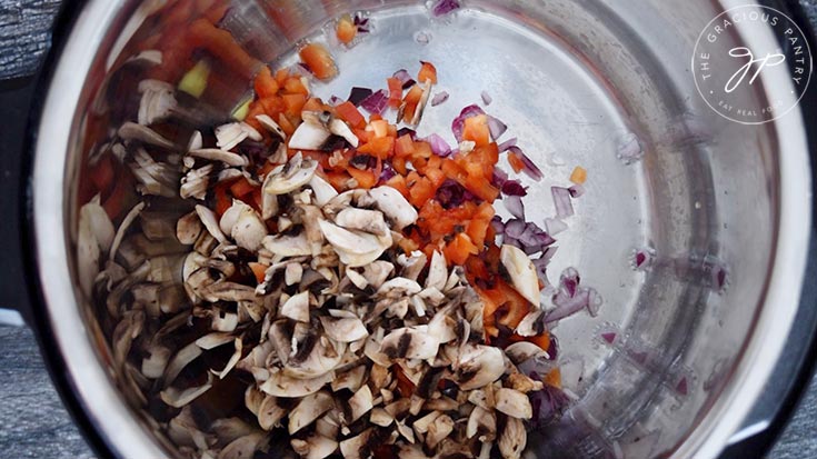 The vegetables added to the insert for sautéing.