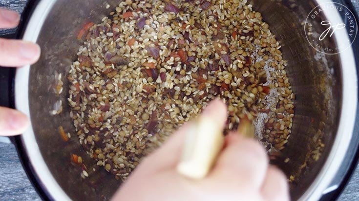 Sautéing the rice and lentils with the spices and vegetables in this Instant Pot Lentils And Rice Recipe.