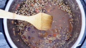 Vegetable broth added to the Instant Pot for cooking this Instant Pot Lentils And Rice Recipe.