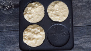 Leftover Oatmeal Pancakes batter cooking on a pancake maker.