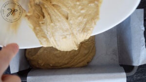 Pouring the Peanut Butter Bread batter into the loaf pan.