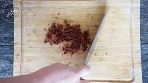 Chopping the bacon for this Roasted Potato Salad Recipe