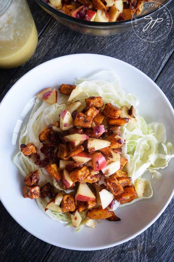 And overhead view of the served Roasted Potato Salad over a bed of shredded cabbage.