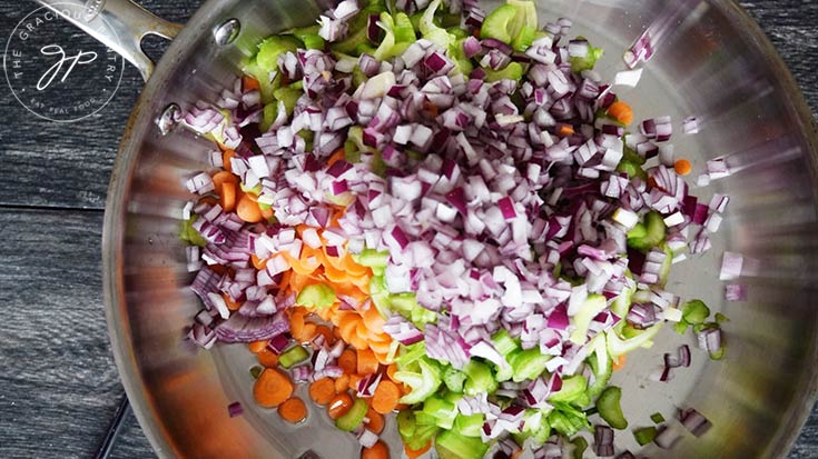 Adding the carrots, celery and onions to the skillet for this Slow Cooker Curry Lentil Soup Recipe