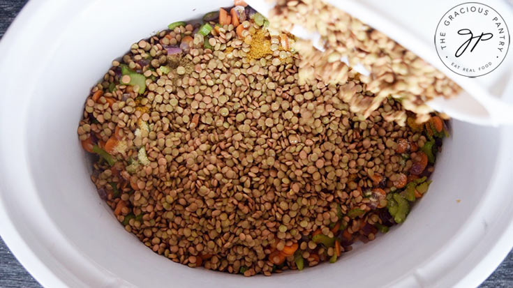 Adding the lentils to the slow cooker to make this Slow Cooker Curry Lentil Soup Recipe