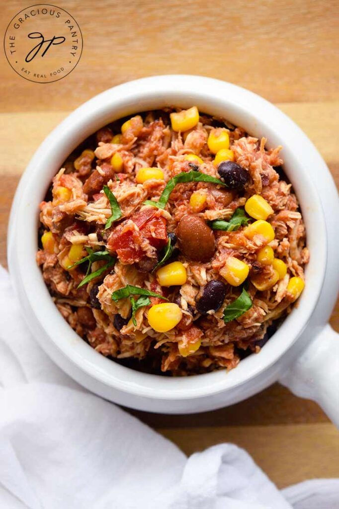 An overhead view looking down into a white bowl filled with Slow Cooker Southwestern Chicken.