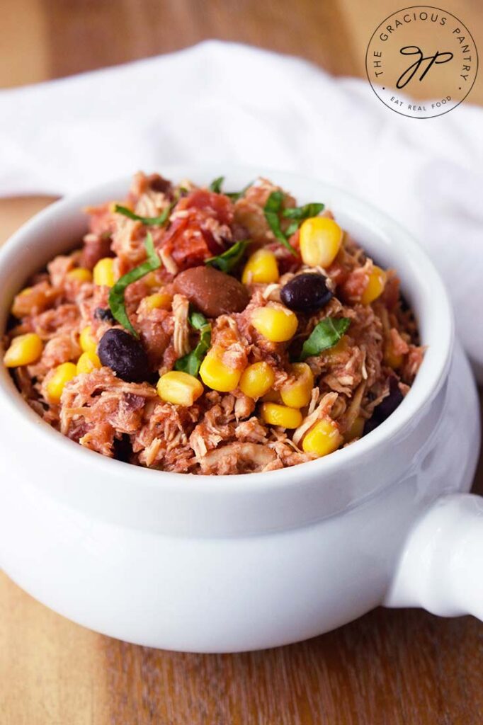 A white crock filled with Slow Cooker Southwestern Chicken.