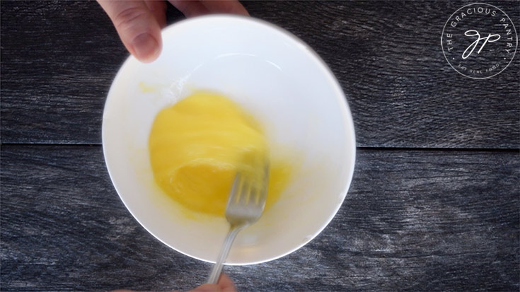 Whisking the eggs for battering these Cajun Zucchini Sticks.