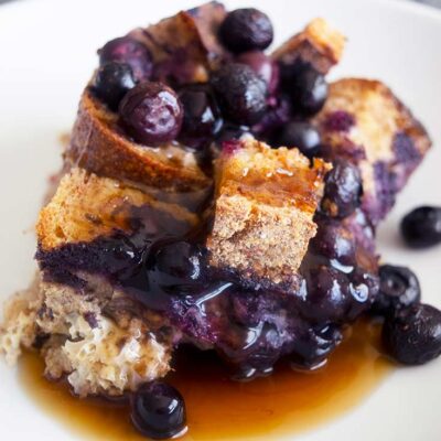 A serving of Blueberry French Toast Casserole served on a white plate.