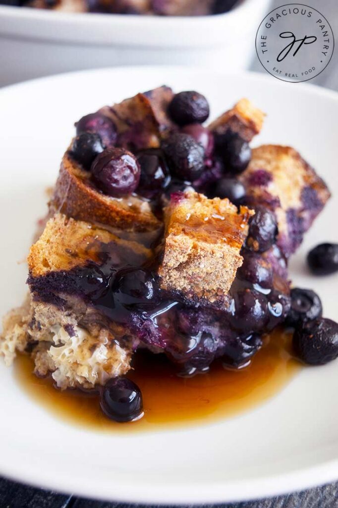 A serving of Blueberry French Toast Casserole served on a white plate.