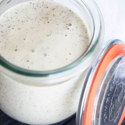An overhead view looking down into a glass jar filled with Dairy Free Ranch Dressing.