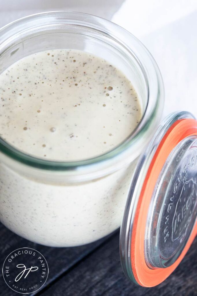 An overhead view looking down into a glass jar filled with Dairy Free Ranch Dressing.