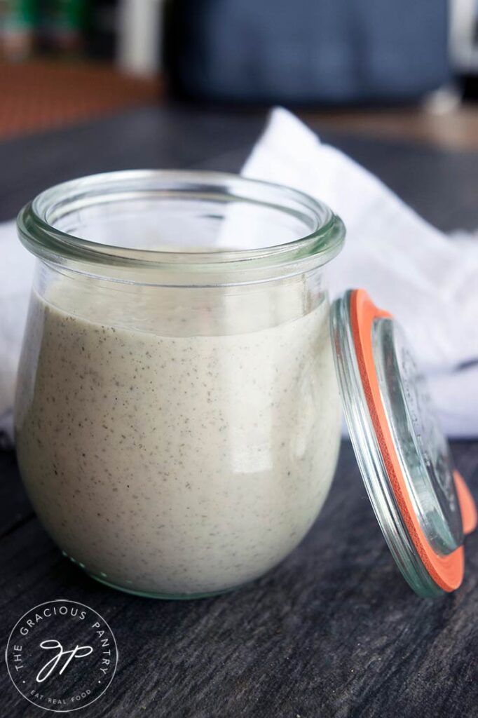 A side view of an open jar of Dairy Free Ranch Dressing.