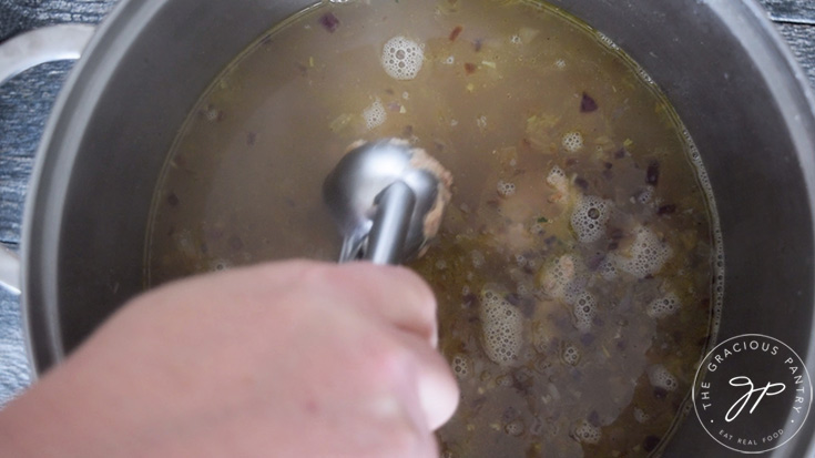 Scooping the meat into the hot broth for the meatballs in this Healthy Italian Wedding Soup Recipe.