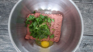 Adding egg to the meat for the meatballs in this Healthy Italian Wedding Soup Recipe.