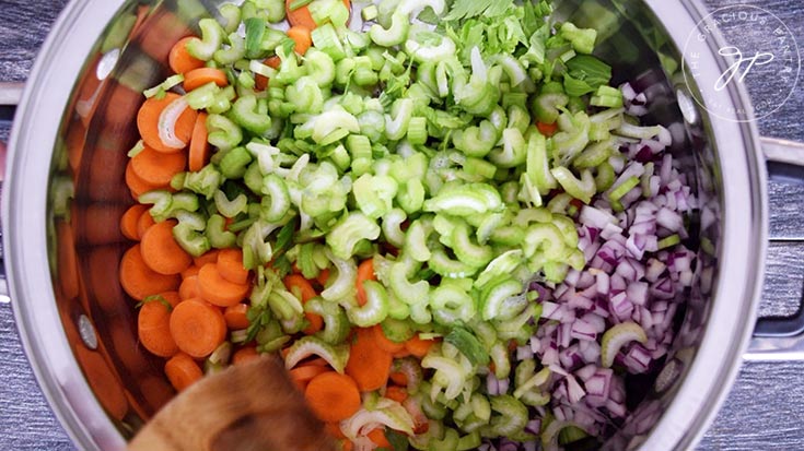 Sautéing the vegetables for this minestrone soup recipe.