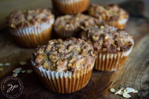 The finished Oat Flour Muffins With Streusel Topping, sitting on a cutting board.