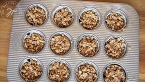 The streusel sprinkled over the top of the muffins, ready for baking.