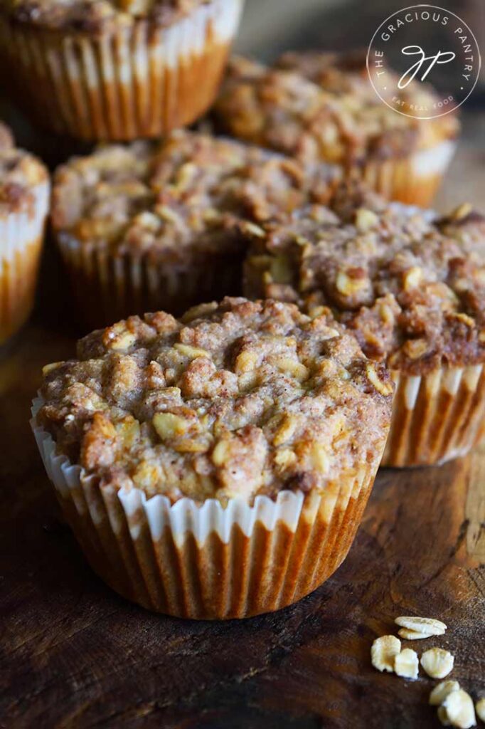 A side view of a group of Oat Flour Muffins With Streusel Topping on a cutting board.