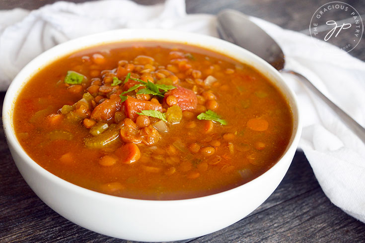 A white bowl filled with Slow Cooker Curry Lentil Soup.