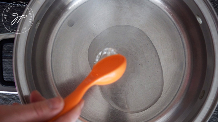 Adding the oil to the skillet to make this Spring Minestrone Soup Recipe