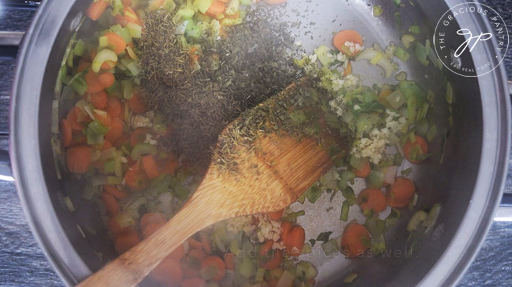 Adding the spices to the pot for this Spring Minestrone Soup Recipe