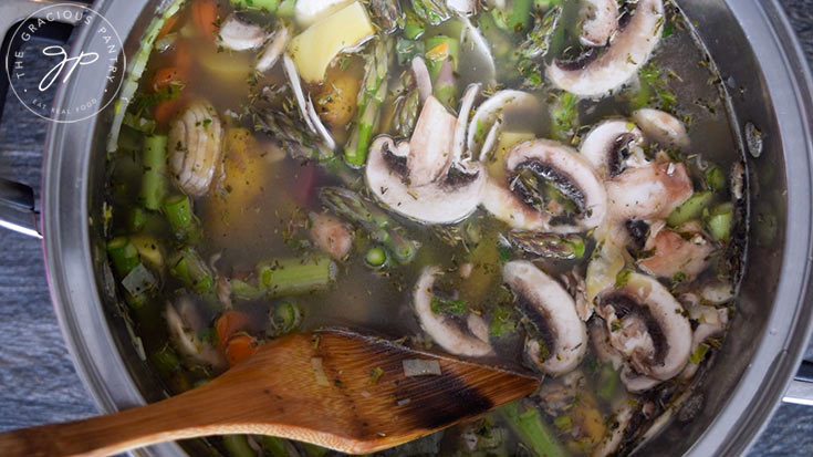 Stirring the pot with broth added for this Spring Minestrone Soup Recipe