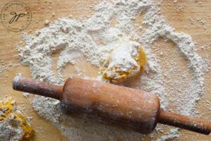 A portion of dough on a floured surface, ready to be rolled out to make this Sweet Potato Flatbread.