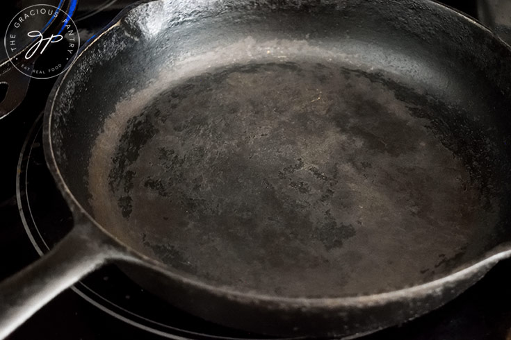 A cast iron skillet sits on the stove, ready to cook this Sweet Potato Flatbread.