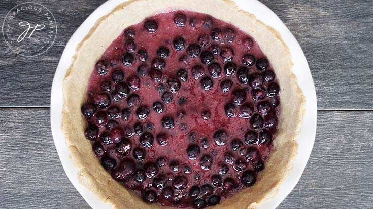 The Blueberry pie filling added to the crust in the pie pan.