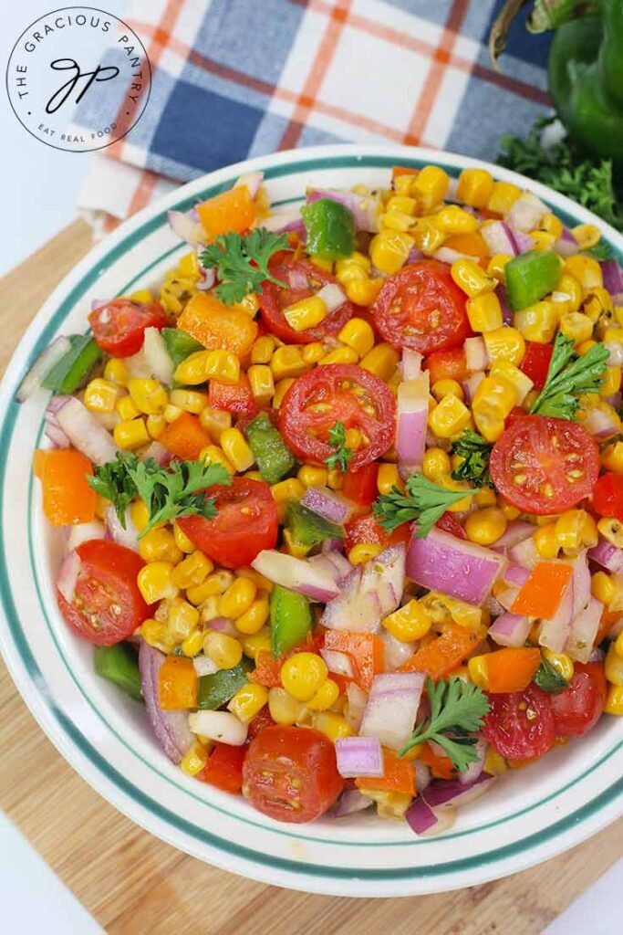 An overhead view looking down into a bowl filled with this Cajun Corn Salad Recipe