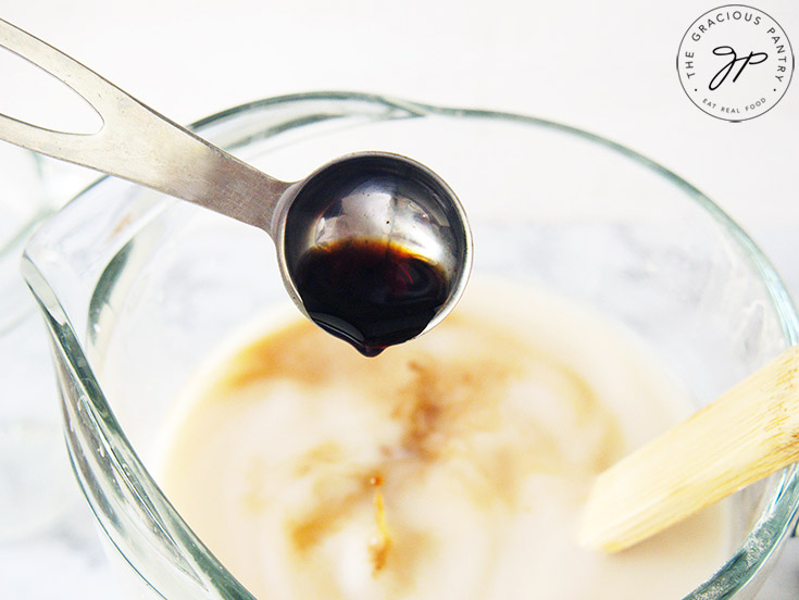 Adding the honey and vanilla extract to the homemade horchata.