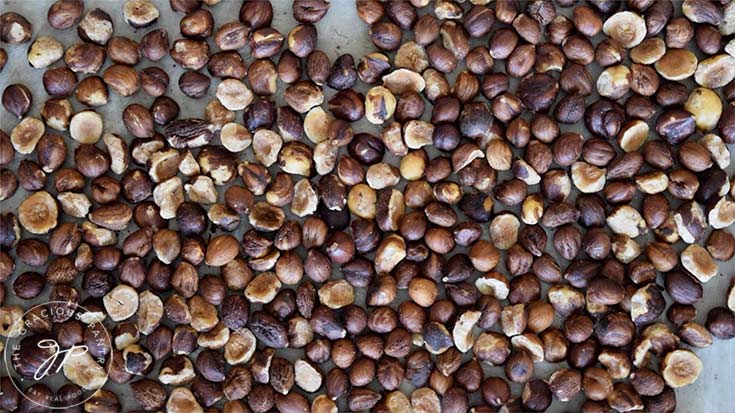 The roasted hazelnuts on a tray for this Homemade Nutella Recipe.