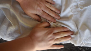 Rolling the skins of the roasted hazelnuts.