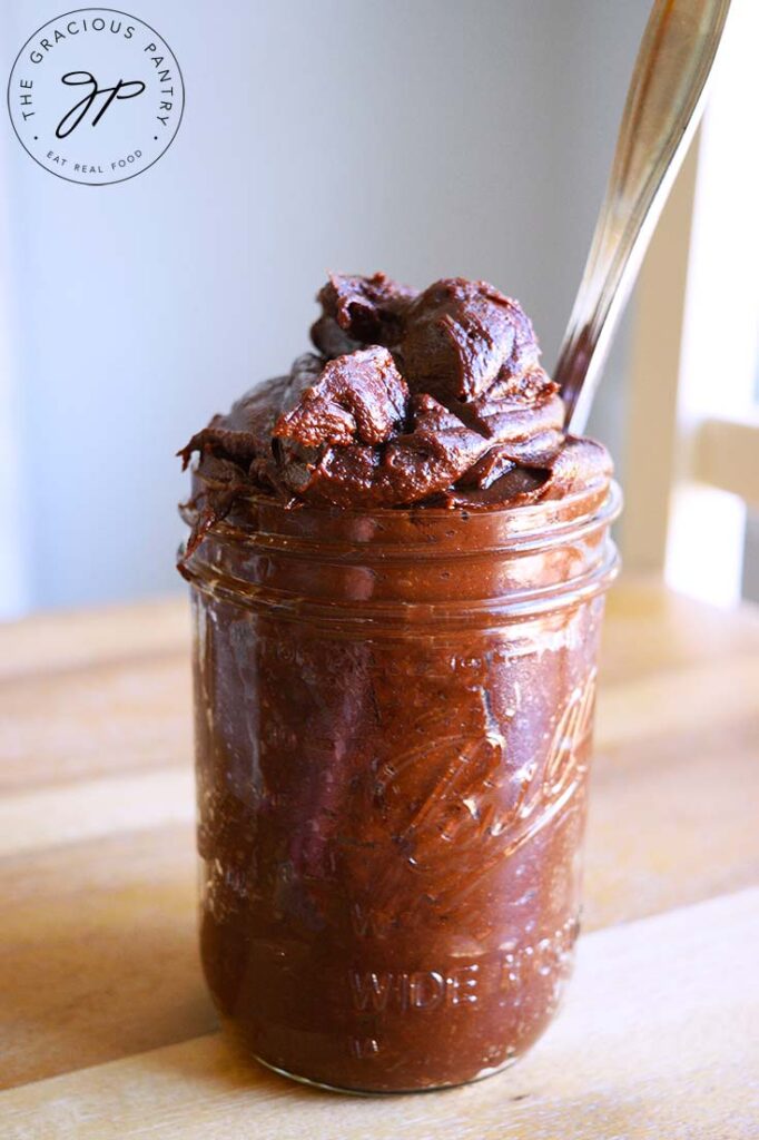 A side view of this Homemade Nutella on a wooden surface.