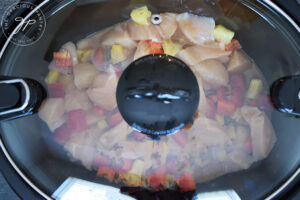 The lid placed on the slow cooker, preparing to cook this Slow Cooker Pineapple Chicken Recipe.