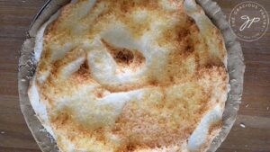 The golden brown top of the just-baked coconut meringue pie.