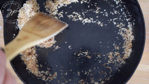 Browning the shredded coconut in a dry pan for topping the coconut cream version of this Coconut Meringue Pie Recipe.