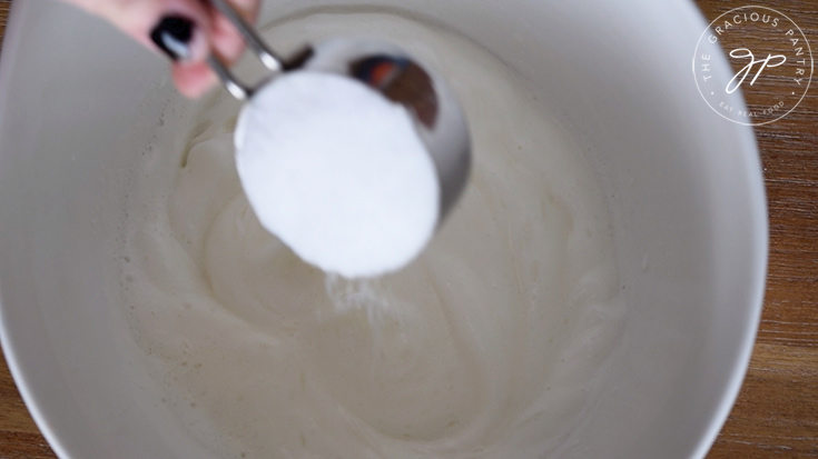 Adding the sweetener to the egg whites.