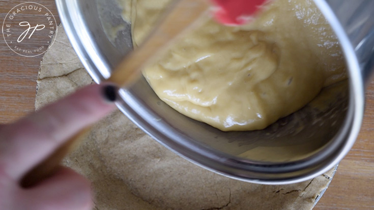 Pouring the thickened pie filling into the pie crust.