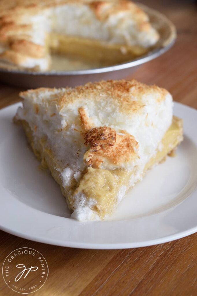 A dingle slice of coconut meringue pie on a white plate.