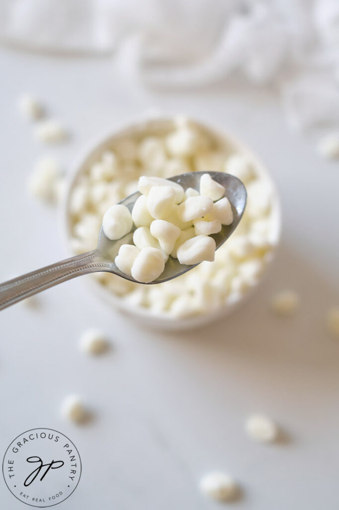 A spoon holds a few Dip N' Dots Ice Cream up to the camera.