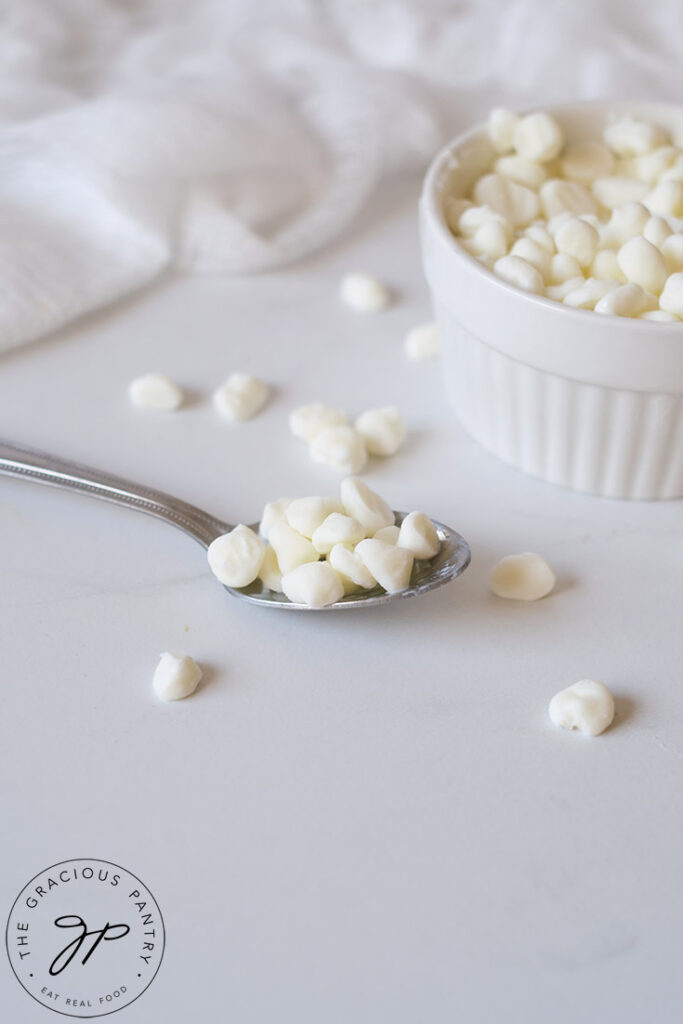 A spoon sits on the side of a bowl filled with Dippin Dots Ice Cream.