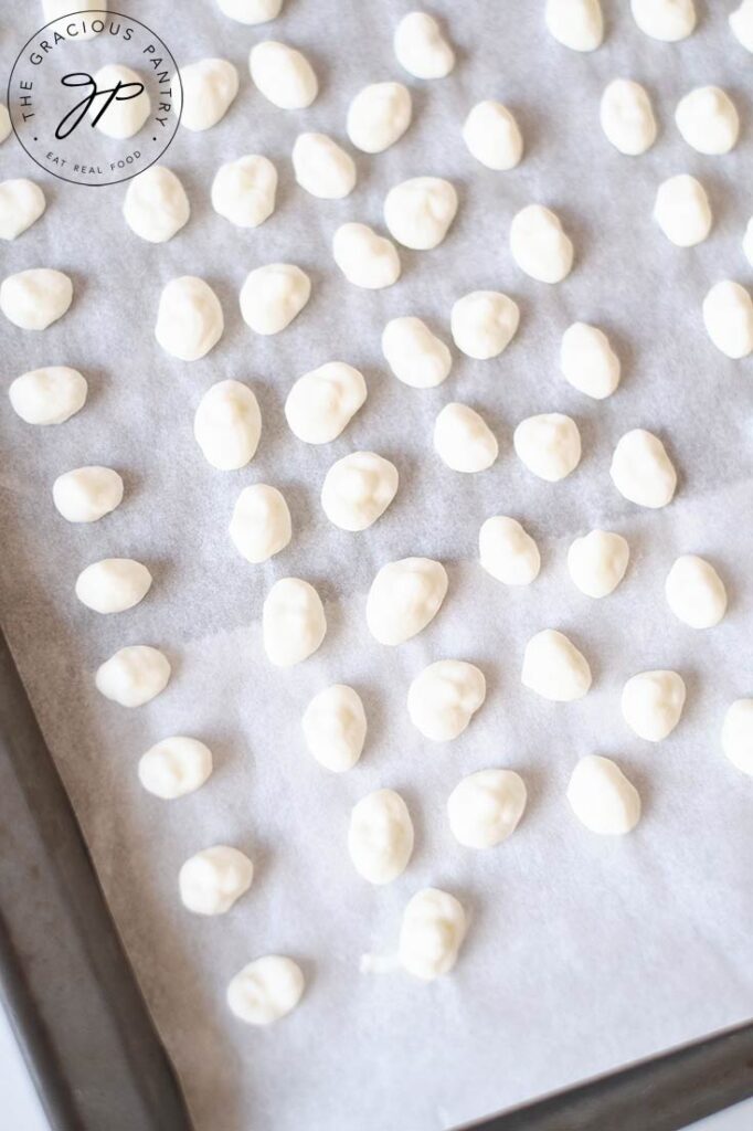 Dippin Dots Ice Cream dots on a parchment lined cookie sheet, ready to freeze.