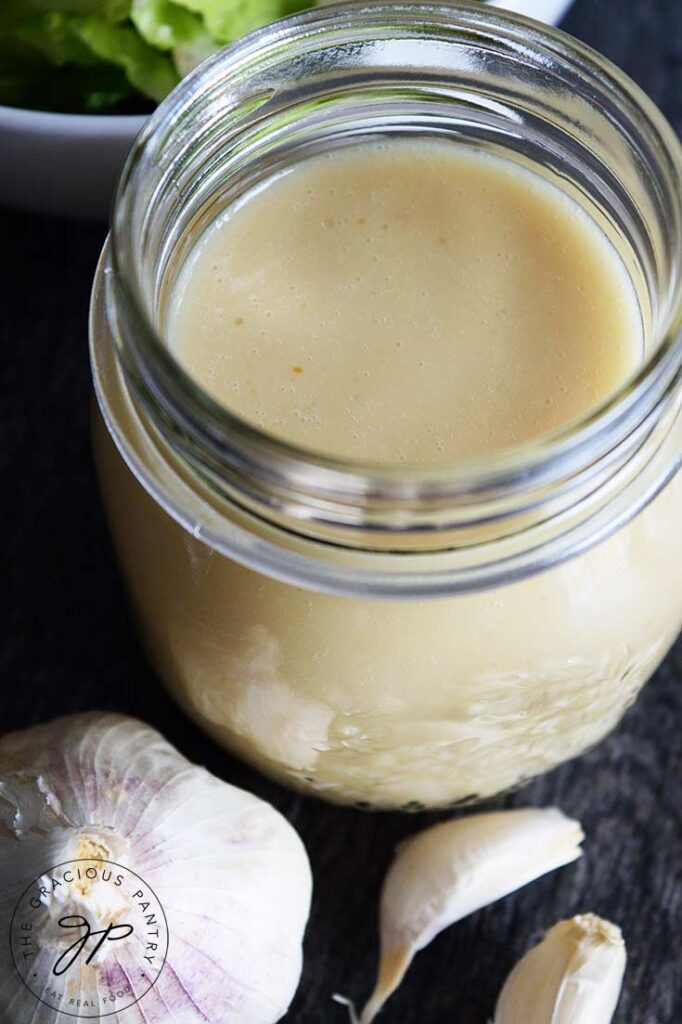 And overhead look at a jar filled with Roasted Garlic Vinaigrette, looking down into the jar from overhead.