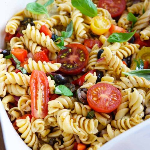 A white serving bowl filled with this Vegetable Pasta Salad Recipe.