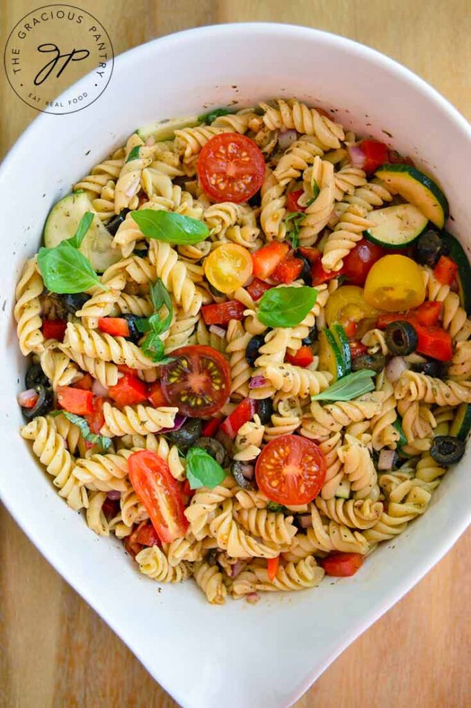 An overhead view of this Vegetable Pasta Salad in a white serving bowl.