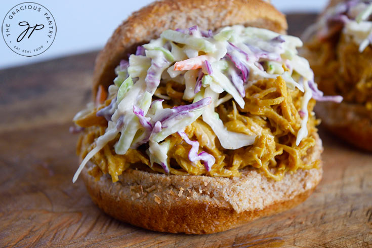 The finished Carolina Gold BBQ Chicken Sandwiches on a cutting board.