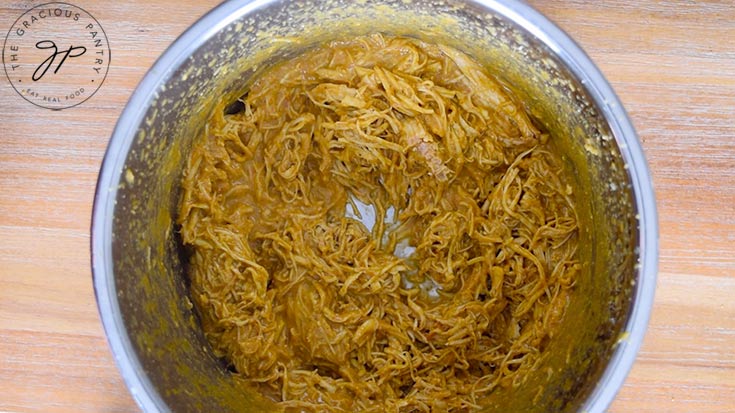 The cooked chicken, shredded in the Instant Pot. Ready to make these Carolina Gold BBQ Chicken Sandwiches.