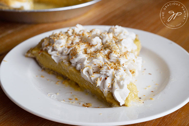 A single slice of the finished coconut cream pie on a white plate.
